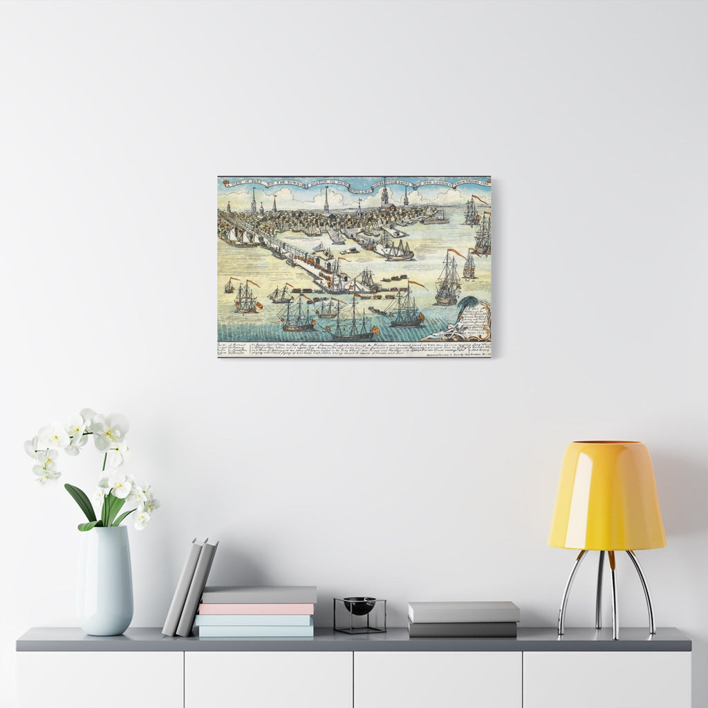 Vintage nautical wall art canvas print featuring sailing ships and an old map, displayed above a modern shelf with books, a vase of white flowers, and a yellow lamp.